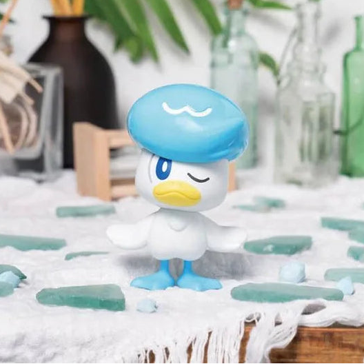 Completed Bandai Quaxly Pokémon model kit displayed with blue decorative accents