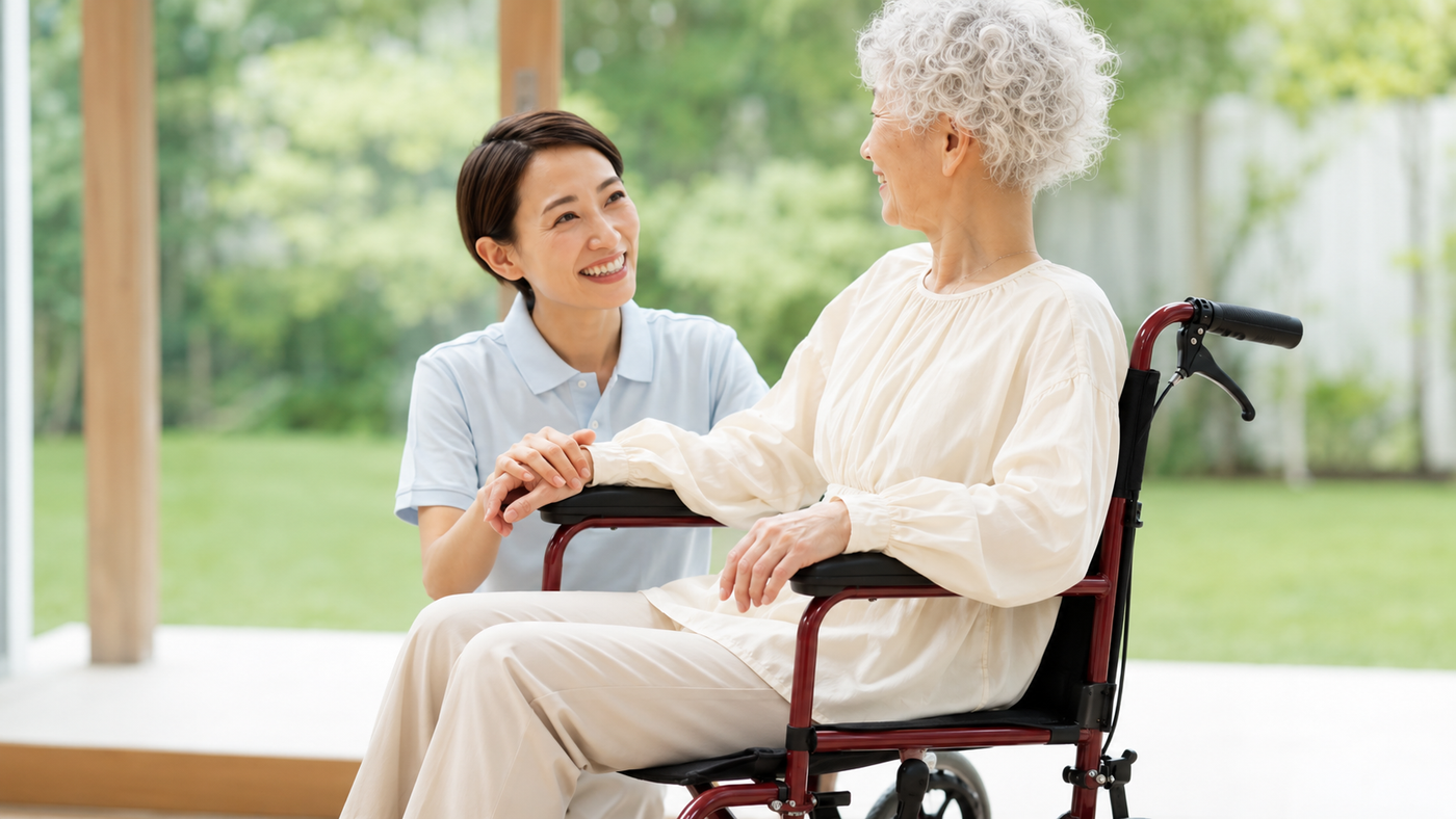 Elderly woman using a red transport wheelchair with caregiver assistance, available through OH Pharmacy home medical equipment and wheelchair rental services